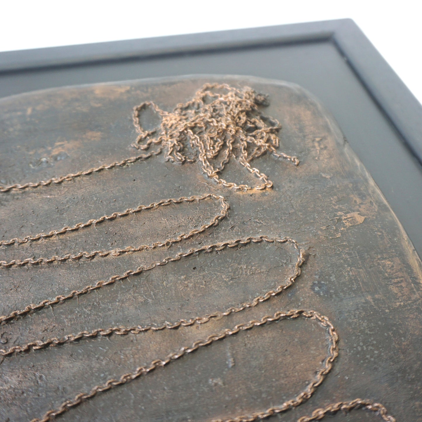 "Chain", bronze plaque on wood